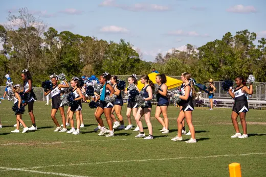 Bobcats cheer squads performing together on the field at halftime