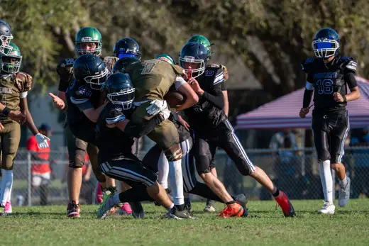 14U Bobcats running back fighting through a tackle
