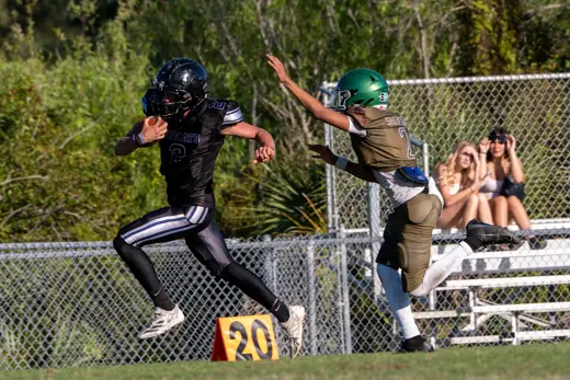 14U Bobcats players leaping at the 20-yard line