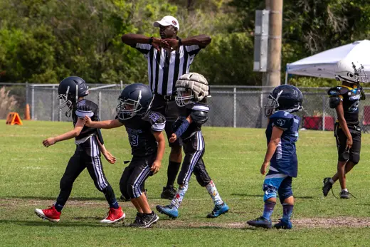 6U Bobcat celebrating on a teammate's shoulders after the game