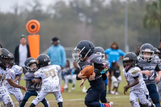6U Bobcats quarterback launching a pass