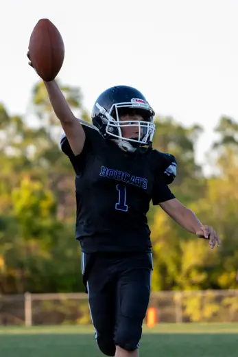 Bobcats player raising the football in celebration