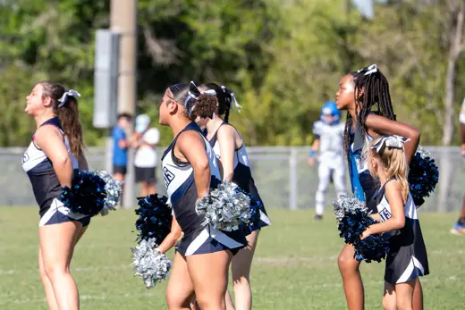 Bobcats cheer squad with pom poms at a home game